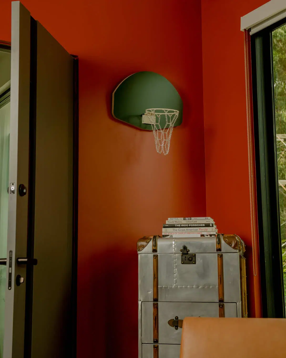 A Green Wooden Hoop in a room with red walls.