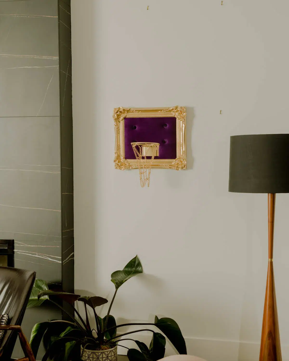 A living room with a striking Purple Velvet Hoop wall decoration.