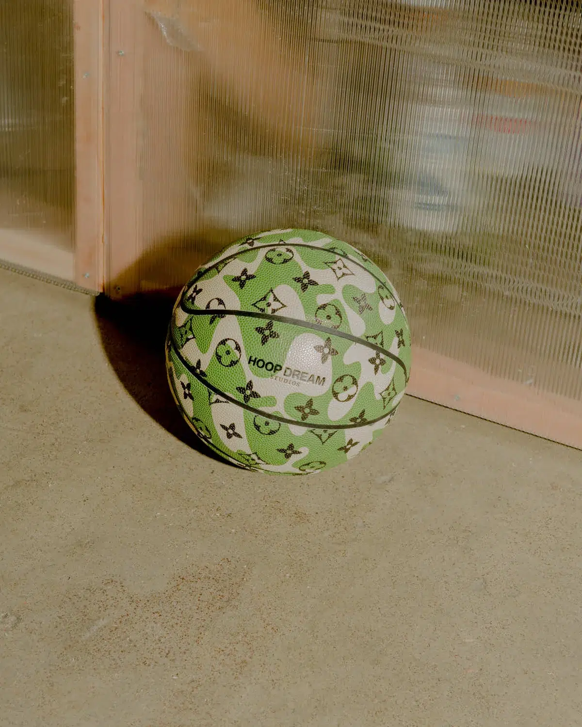 A LV Camo Ball resting in front of a window.