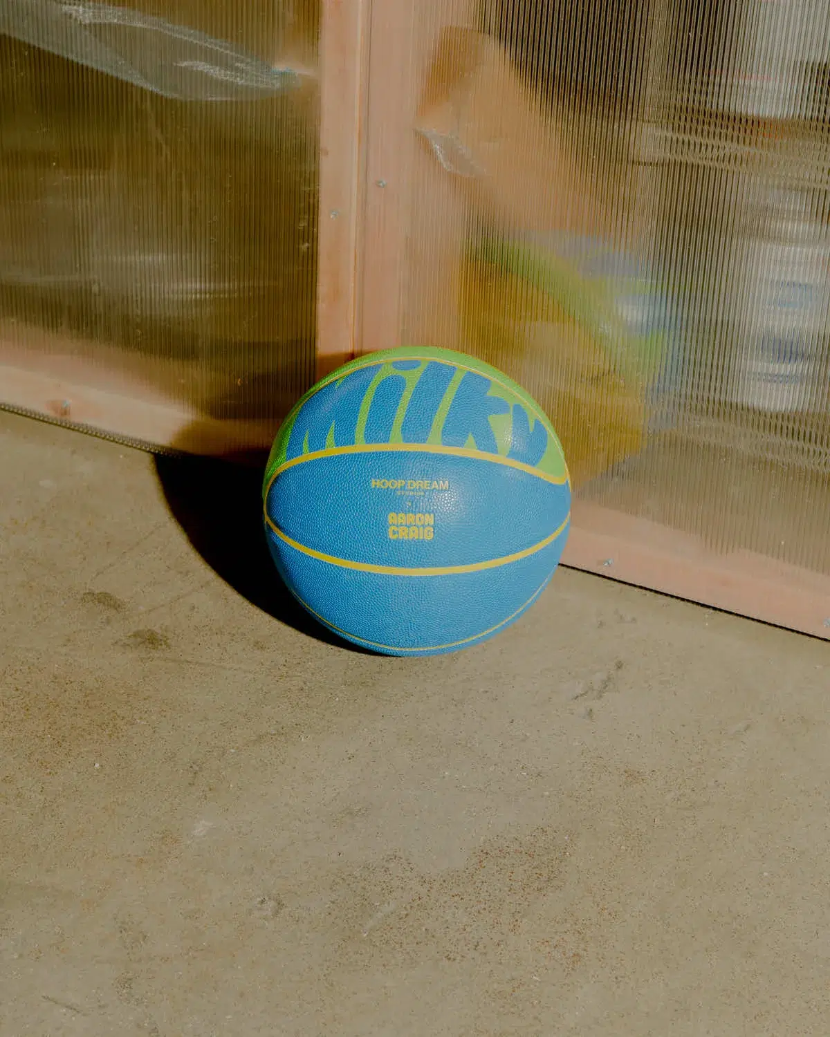 A LV Camo Ball resting on a concrete surface.