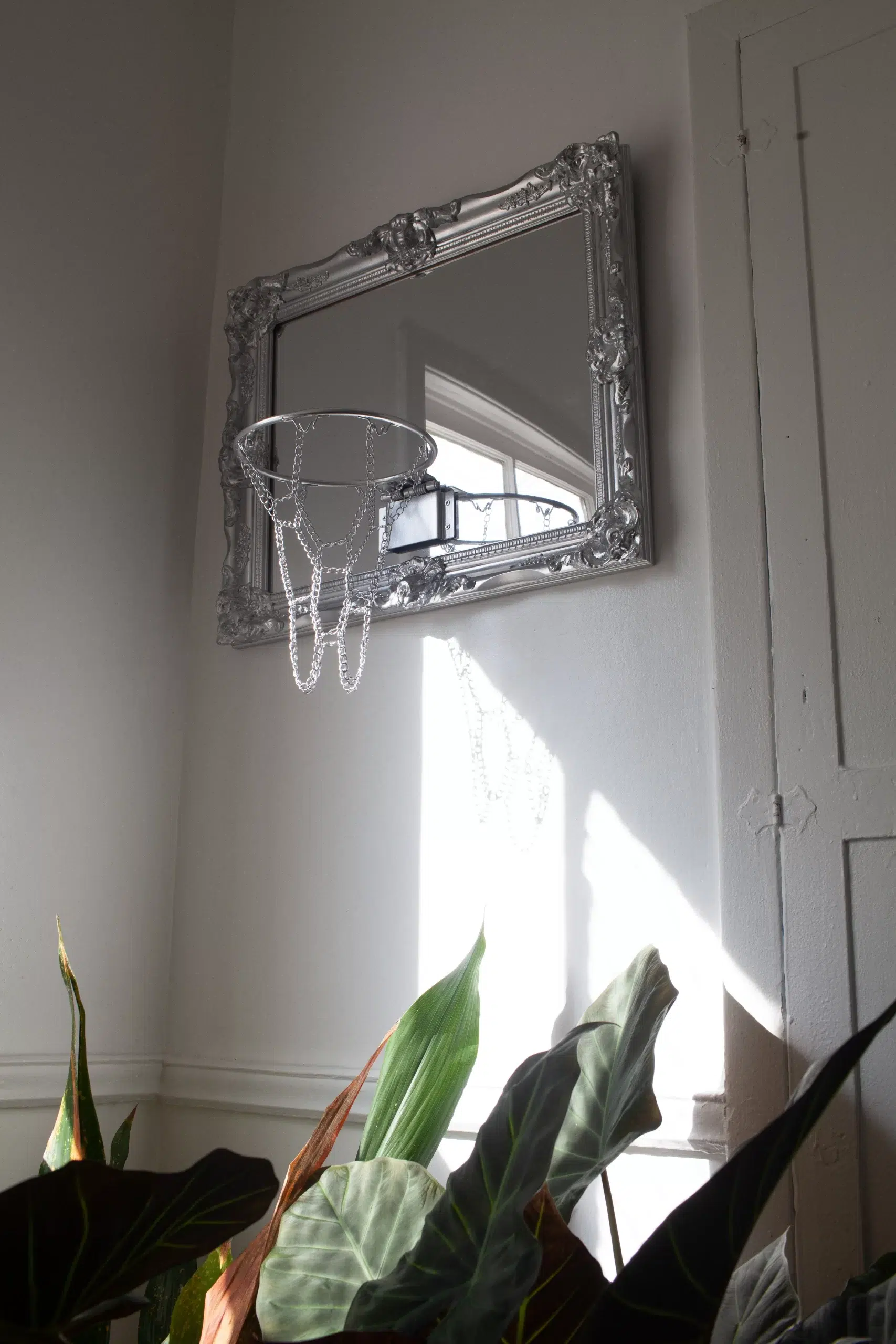 A mirror adorned with a hanging Mirror Hoop.