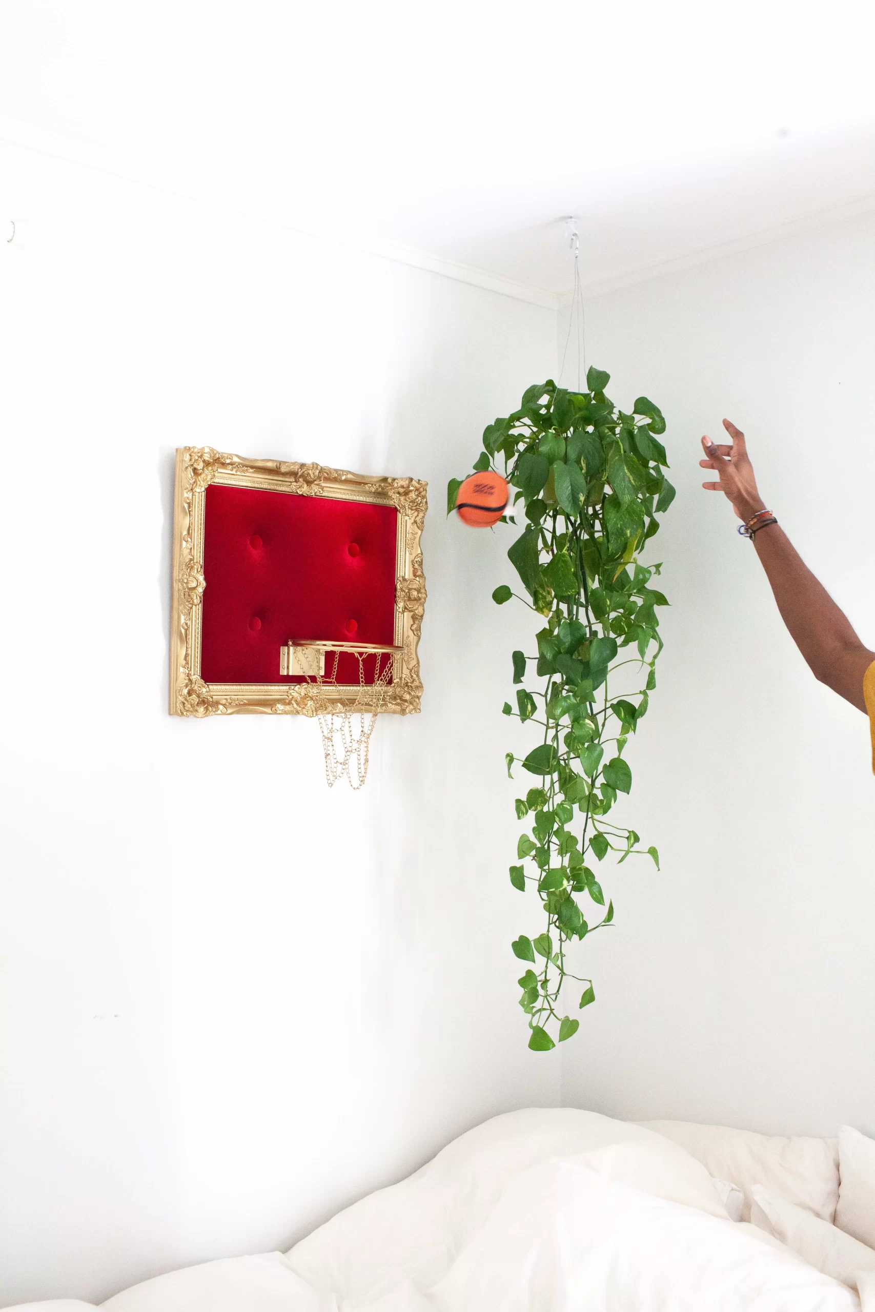 A man showcasing a Red Velvet Hoop on a wall.