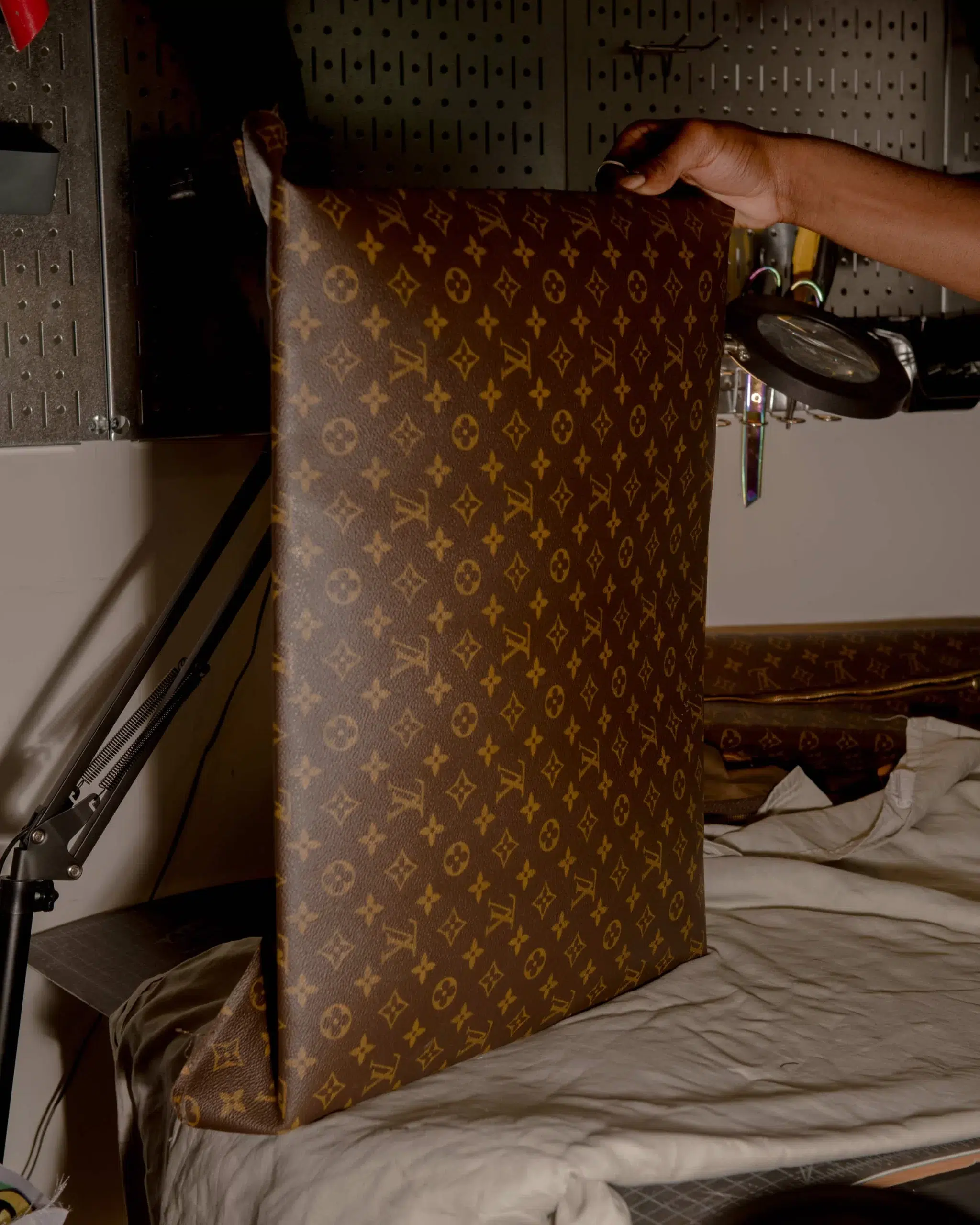 A man showcasing a Louis Vuitton Hoop bag.