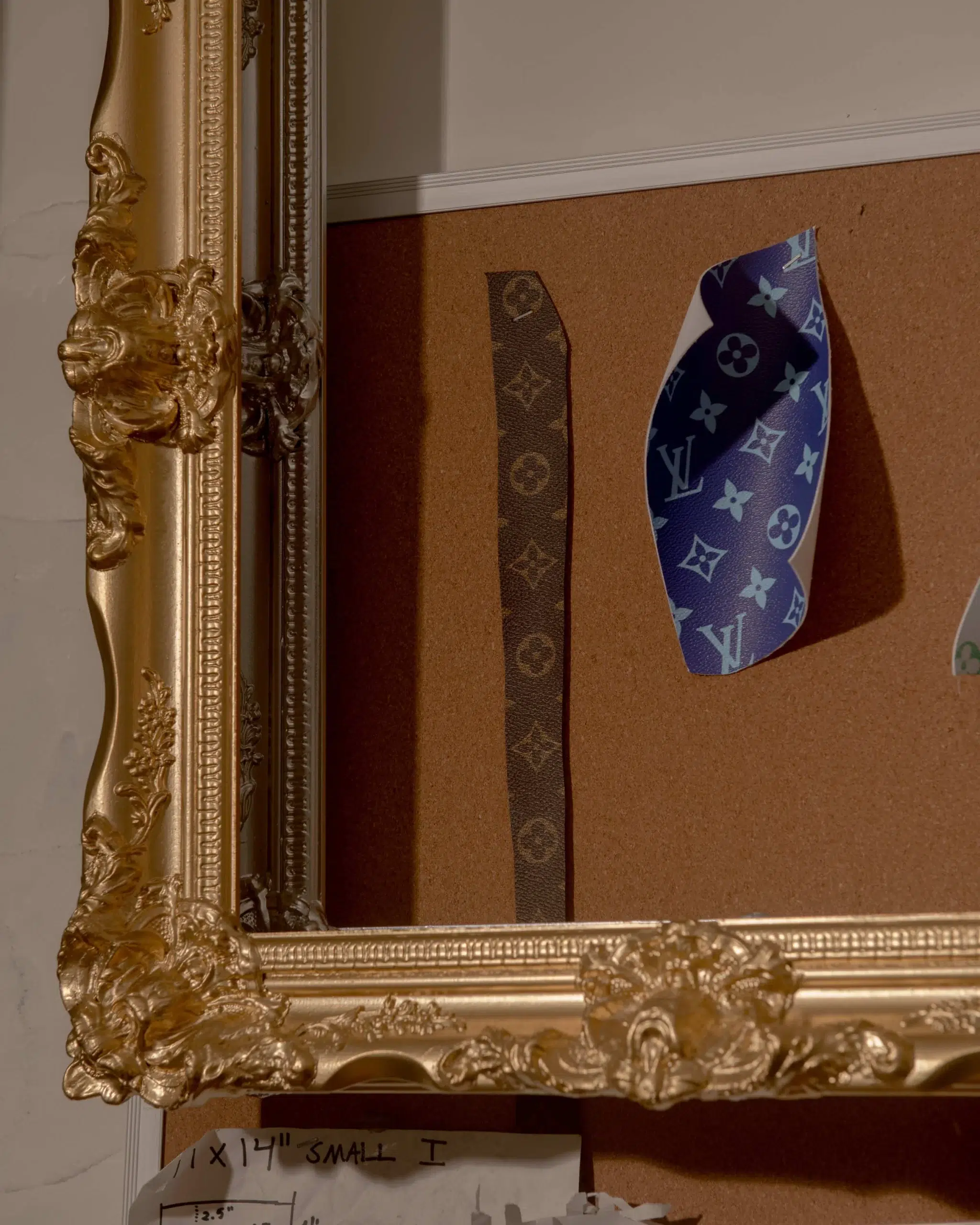 A gold-framed picture featuring a Louis Vuitton Hoop.