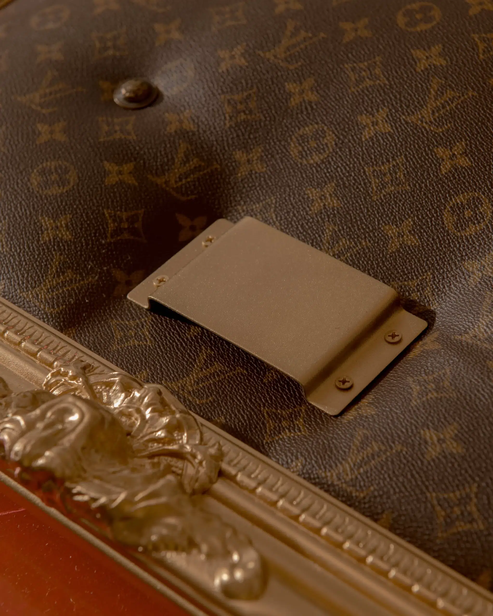 A Hoop suitcase with a Louis Vuitton handle.