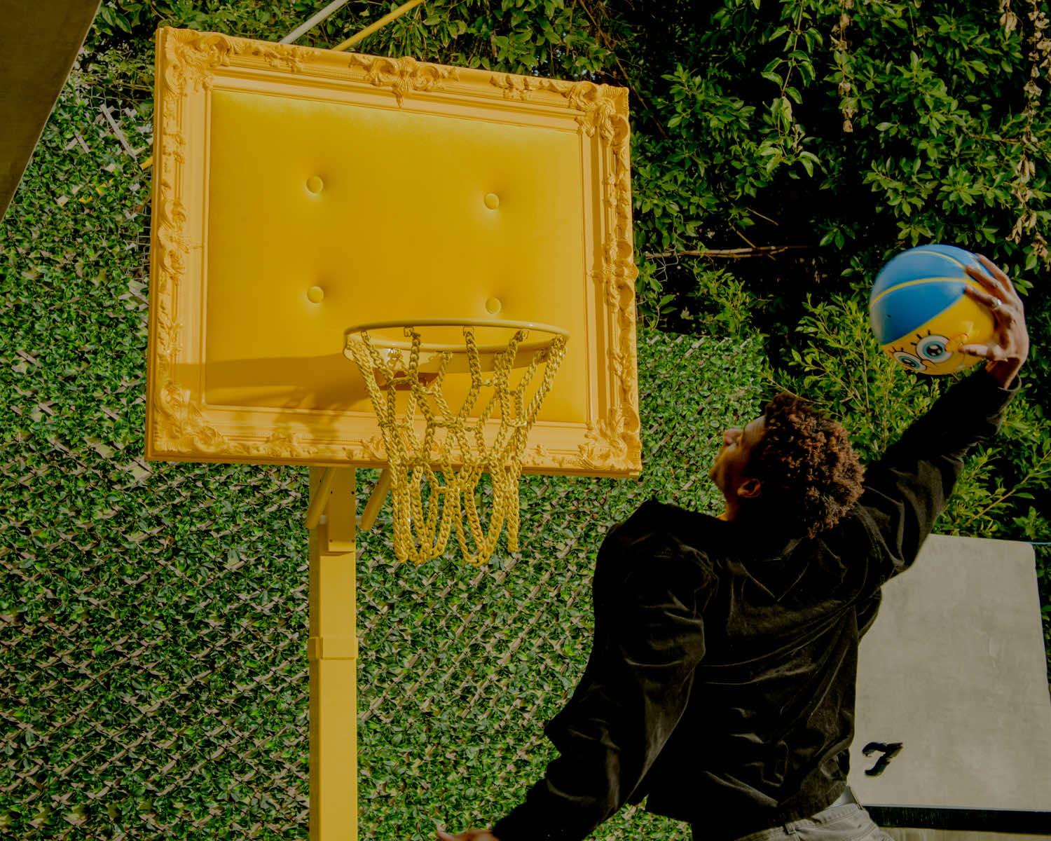 A man jumping over a basketball hoop.
