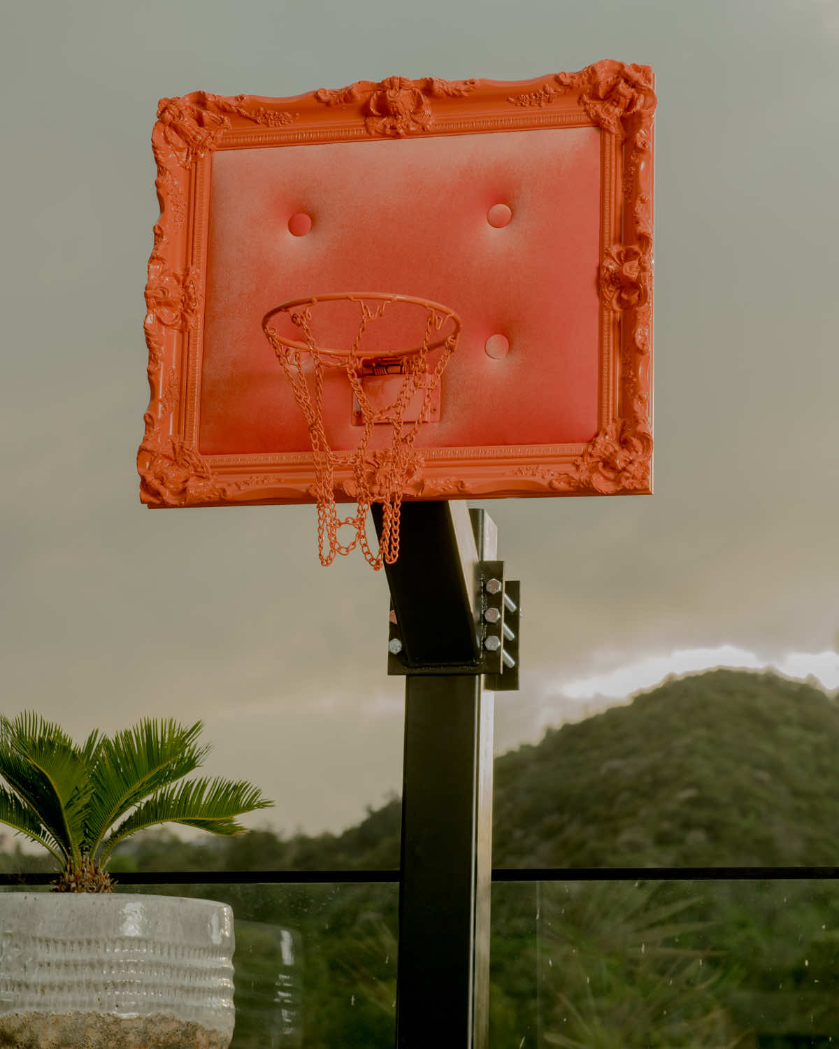 A basketball hoop with a picture frame on it.