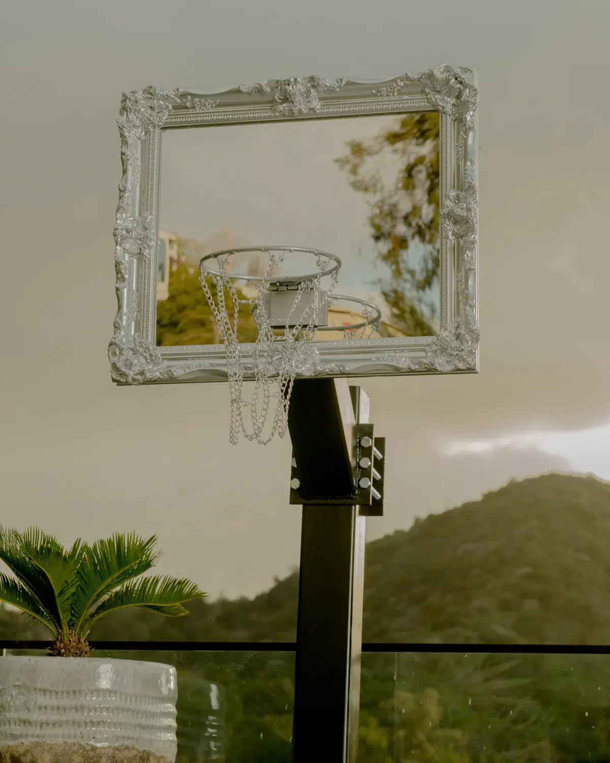 A basketball hoop framed in a mirror.