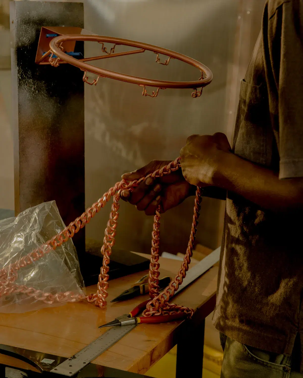 About a man working on a basketball hoop.