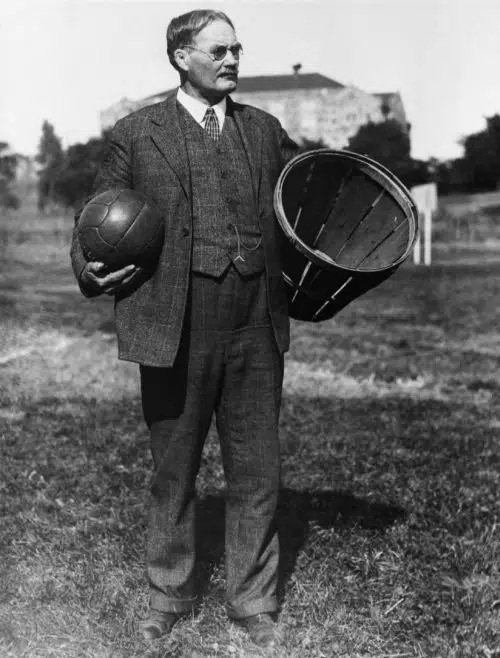 An old photo of a man holding a basket.