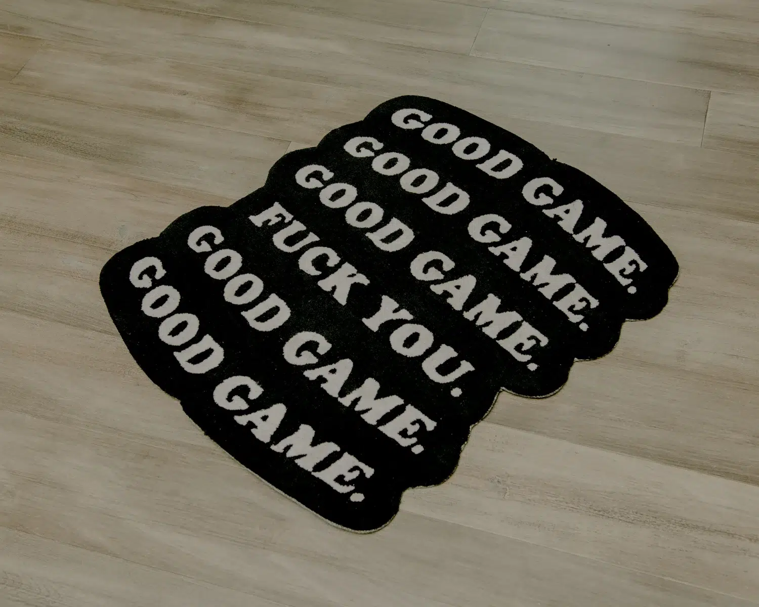 A rug that exclaims "Good game" with a touch of attitude.